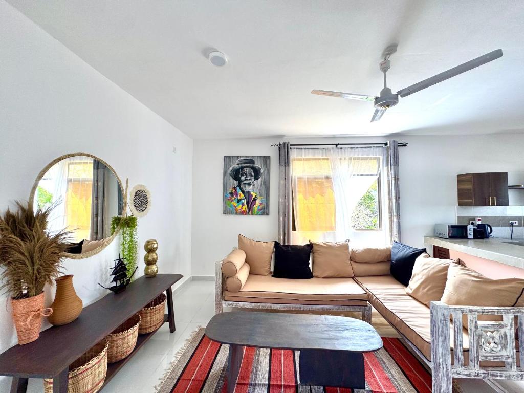 a living room with a couch and a table at KK Homes in Diani Beach