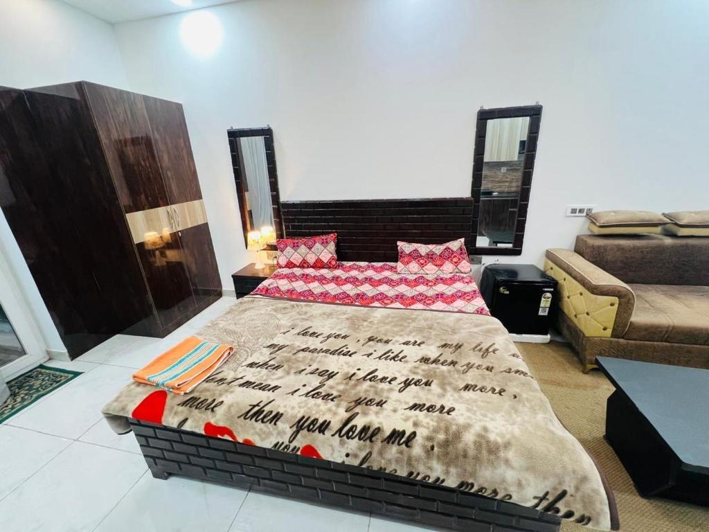 a bedroom with a bed and a couch at Bansal Studio in Noida