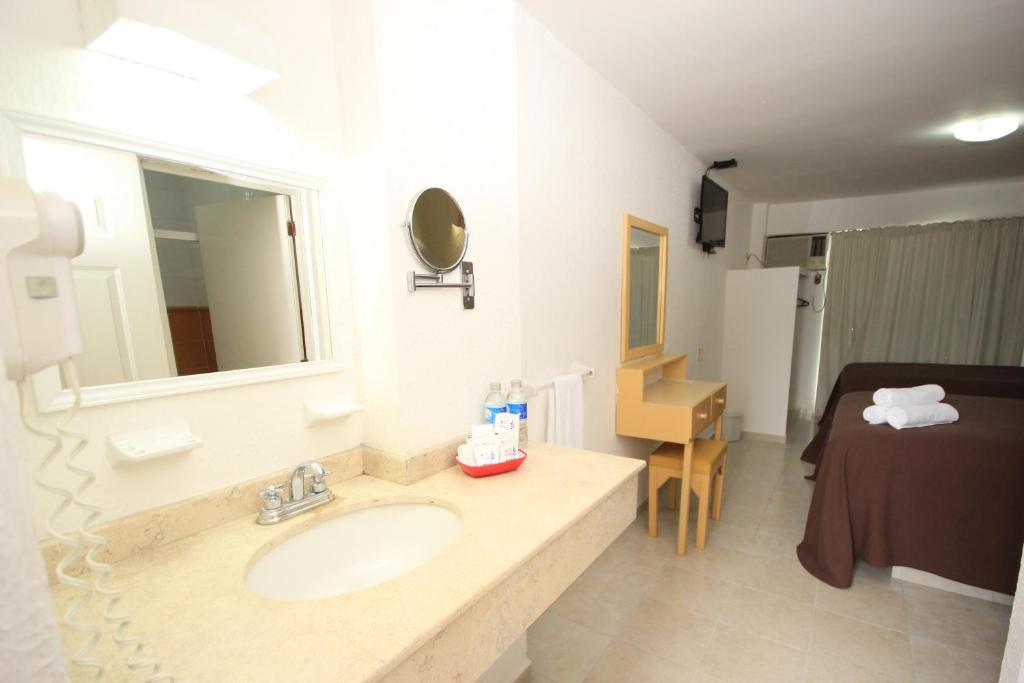 Postel nebo postele na pokoji v ubytování Hotel Posada del Carmen