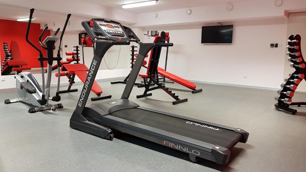 a gym with a treadmill and several exercise bikes at FARO Apartamenty Bliżej Morza in Kołobrzeg