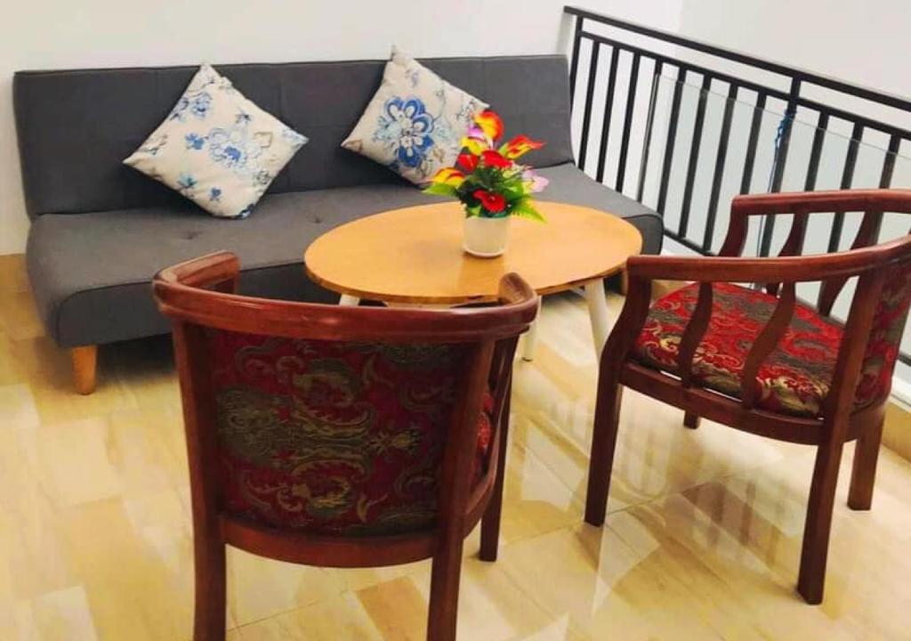a living room with a couch and a table and chairs at Mie's Homestay in Da Nang