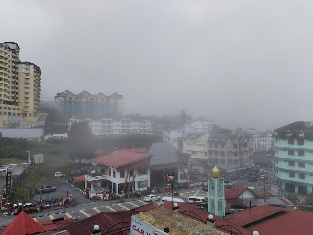 a view of a city with buildings and a clock tower at Star Regency Home Stay in Brinchang