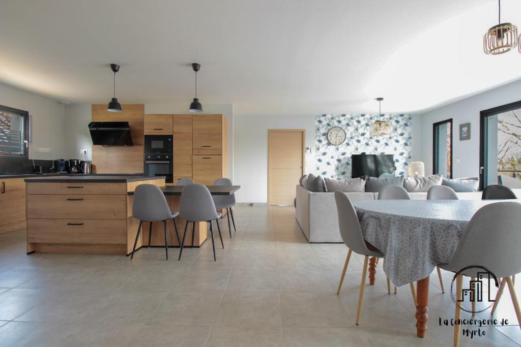 a kitchen and living room with a table and chairs at La Vigne in Albi