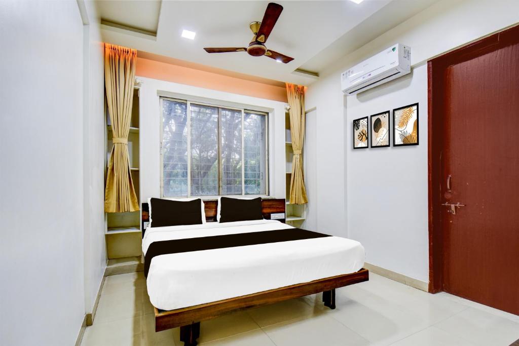 a bedroom with a bed and a window at Super Collection O Balewadi formerly Woods Regency in Pune