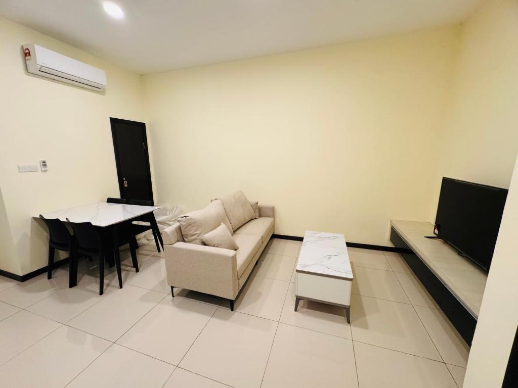 a living room with a couch and a table at City Apartment next to The Spring in Bintulu