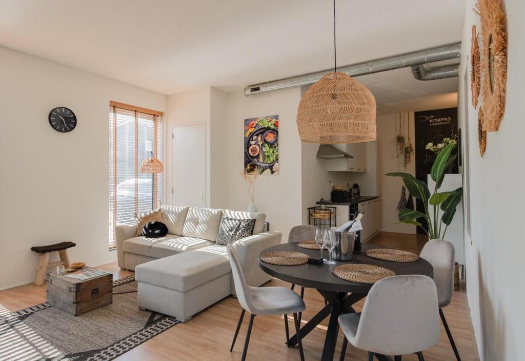 a living room with a table and a couch at Lodge in Loosdrecht-Amsterdam in Loosdrecht