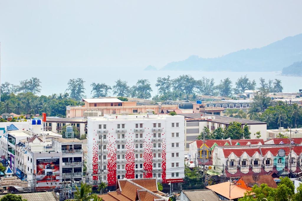 a city with a large white building with christmas decorations at Easy Planet Phuket Patong in Patong Beach
