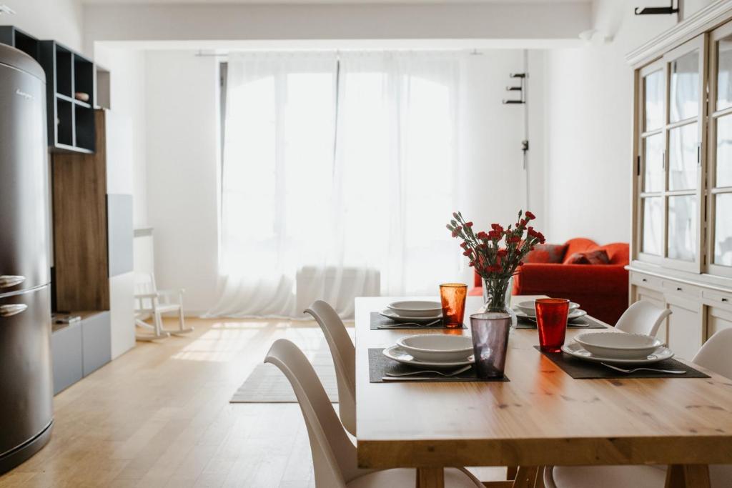 a kitchen and dining room with a wooden table at GuestHost - Mecenate Bright Apartment Milan in Milan