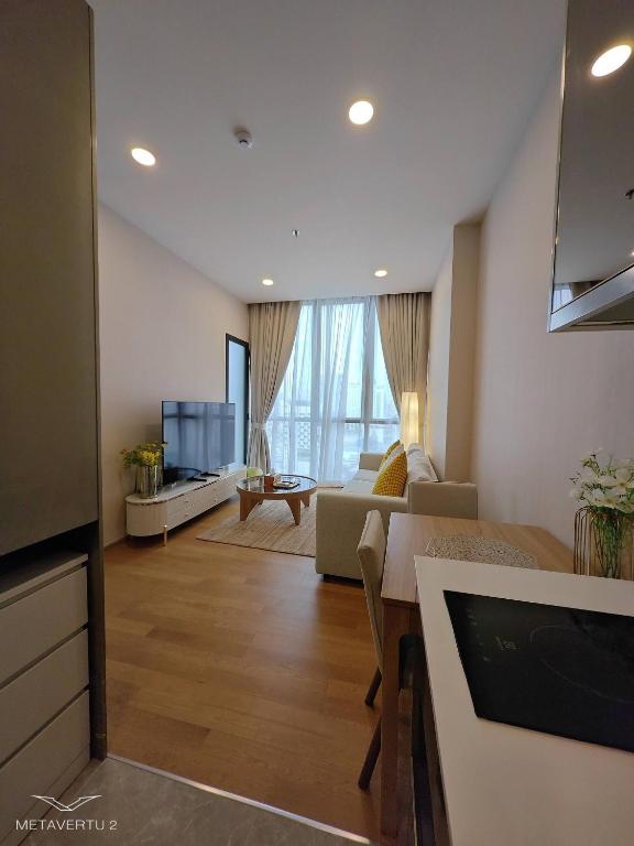 a living room with a couch and a tv at Brand New 2 bedroom near Paragon in Pratunam