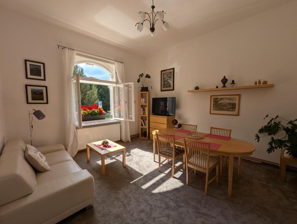 a living room with a table and a couch at U Bílého Beránka in Děčín