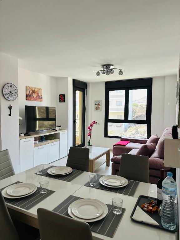 a kitchen and living room with a table and chairs at Malpais in Puertito de Güímar