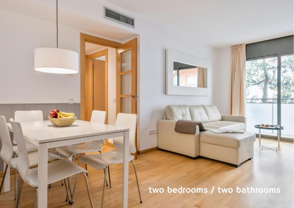 a living room with a table and a couch at Inside Barcelona Apartments Princep in Barcelona