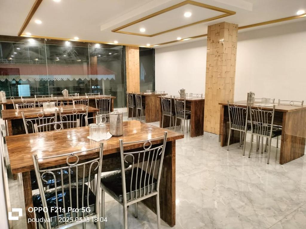 a dining room with wooden tables and chairs at lachung Bliss-Inn Hotel in Lachung
