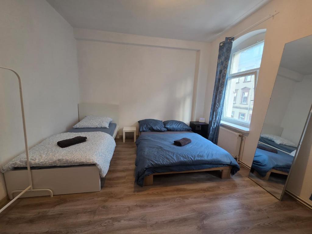 a bedroom with two beds and a mirror at perfect apartment in Freiberg in Freiberg
