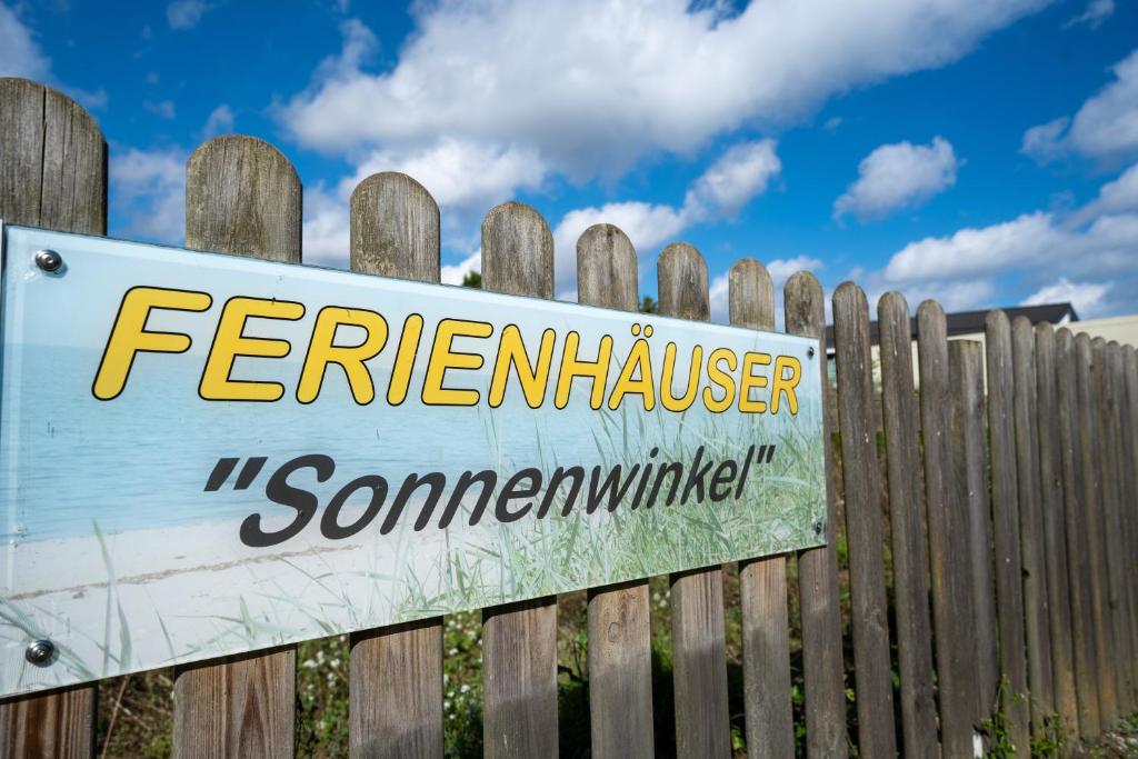 a sign attached to a wooden fence at Haus Sonnenwinkel Bungalow 6 in Dahme
