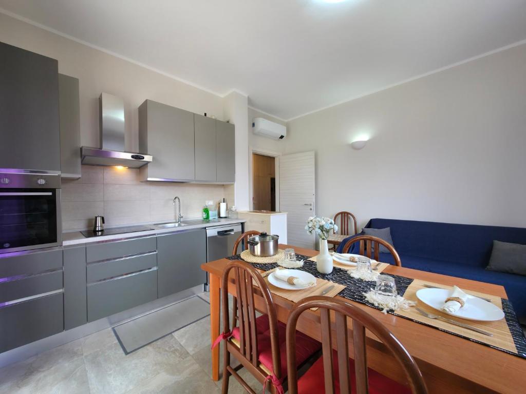 a kitchen and dining room with a table and chairs at 200m from Beach, New Central Apt, AC, WiFi in Loano