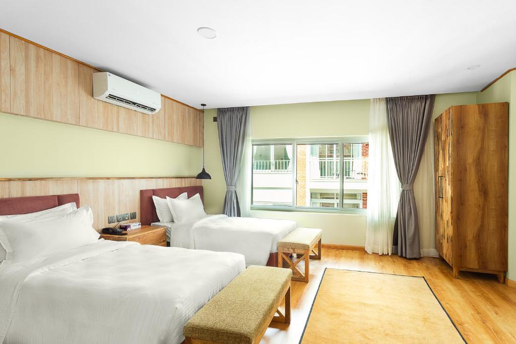 Ένα ή περισσότερα κρεβάτια σε δωμάτιο στο Nova Tara Hotel Kathmandu