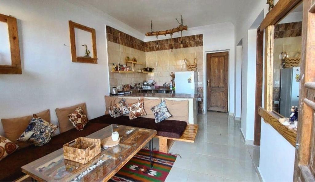 a living room with a couch and a table at Cozy 2 bedrooms in eel gardens, Dahab in Dahab