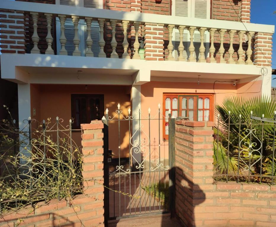 a house with a gate and a fence at Tu Jardín Secreto Cachi in Cachí