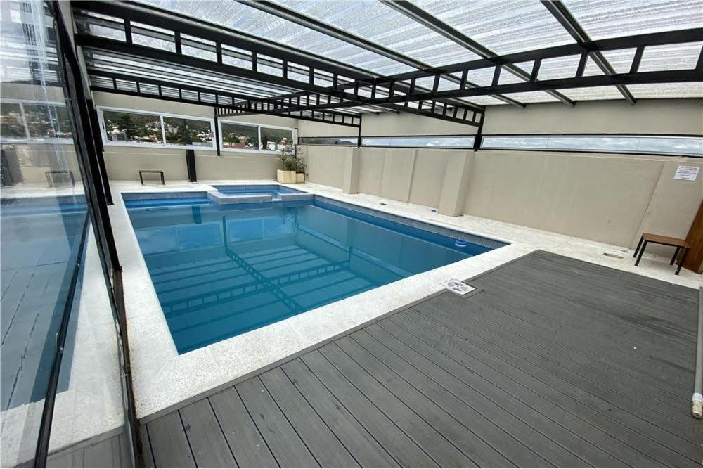 a large swimming pool in a building at Departamento Céntrico Miralejos 3 in Villa Carlos Paz