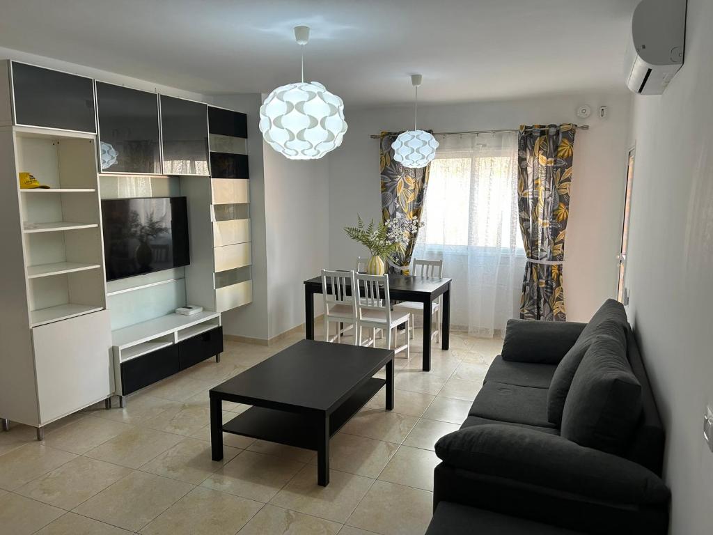 a living room with a couch and a table at Casa Caletillas in Candelaria