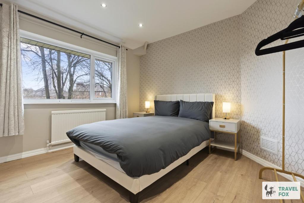 a bedroom with a large bed and a window at Rosie's Central House With Drive Parking in Nottingham