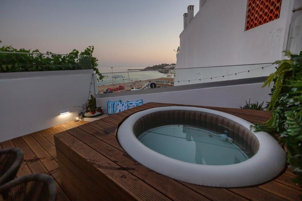 a bath tub sitting on top of a wooden deck at Micului Refugiu in Albufeira