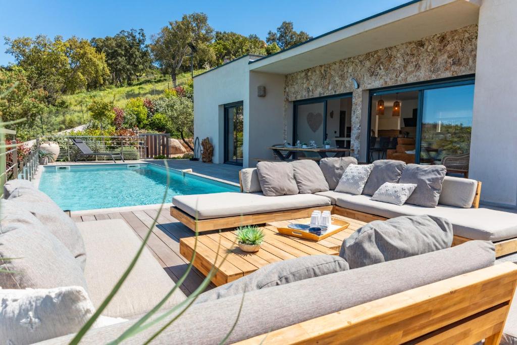a living room with a couch and a swimming pool at Villa Tinoeva Mare di Conca in Conca