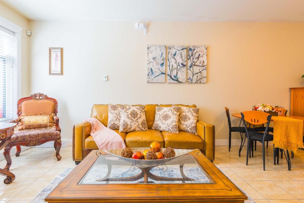 a living room with a couch and a table at Beach Breeze White Rock in White Rock