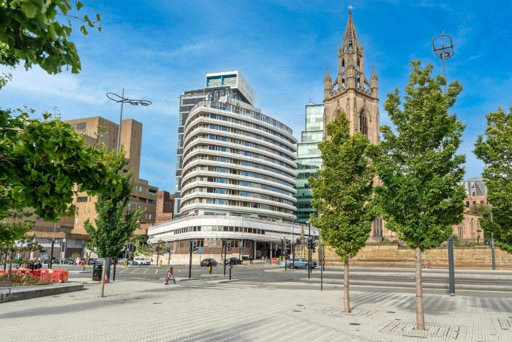 a large building in a city with a clock tower at Atlantic Tower Hotel Liverpool By Sunday in Liverpool
