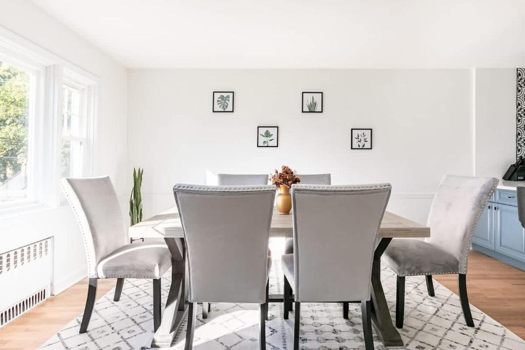 a dining room with a table and chairs at Fire pit ~ Game Room ~ near NYC ~ Modern Luxury in New Rochelle