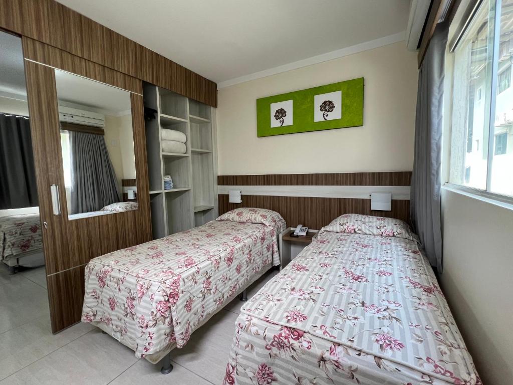 una camera da letto con due letti e una finestra di diRoma Lacqua II direto com o Grupo diRoma com acesso ao Acqua Park e Café da manhã a Caldas Novas