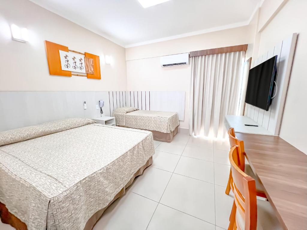 Giường trong phòng chung tại diRoma Spazzio direto com o Grupo diRoma com acesso ao Acqua Park e Café da manhã