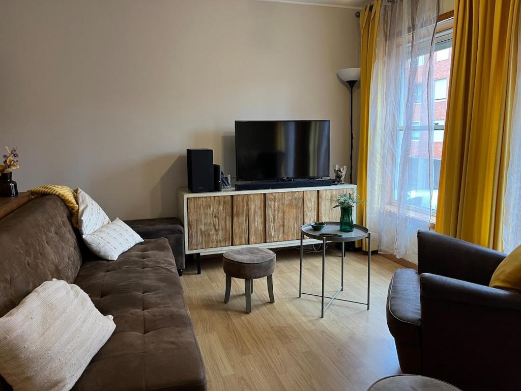 a living room with a couch and a flat screen tv at Porto Nest in Senhora da Hora