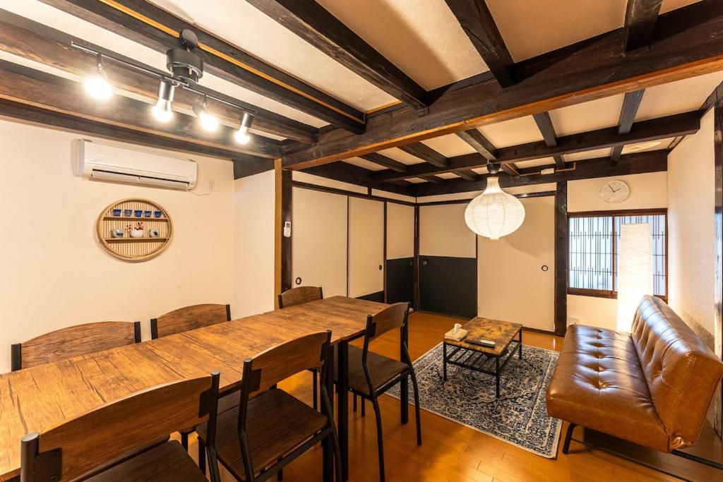 a dining room with a long table and chairs at SkySTAGE十人町 in Nagasaki