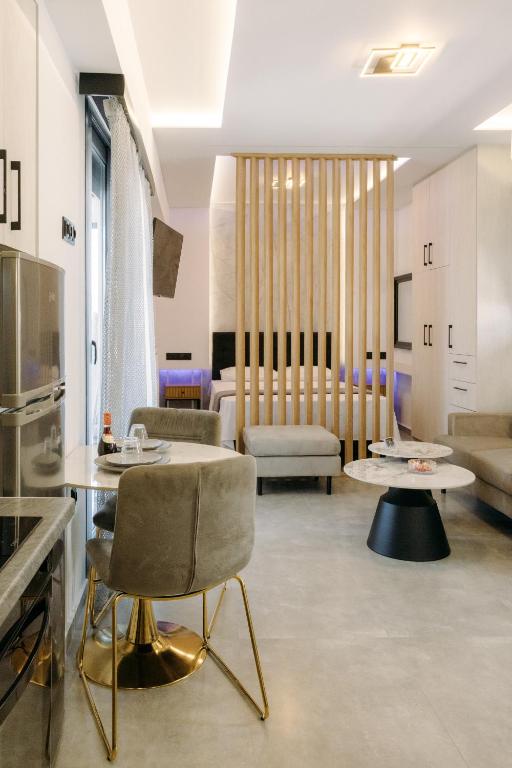 a living room with two tables and a couch at Nuance Residences - Momento in Volos