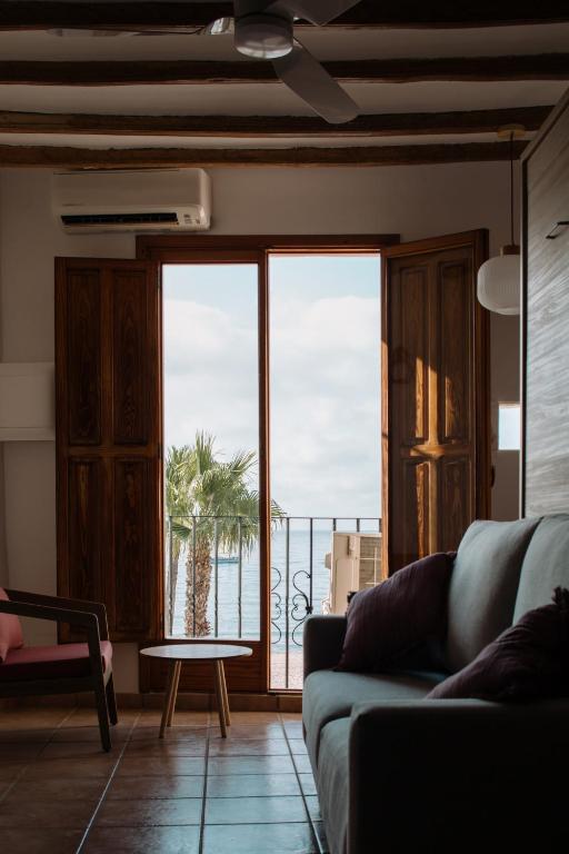 a living room with a couch and a view of the ocean at Esquerdo 22 by Seaward Suites in Villajoyosa