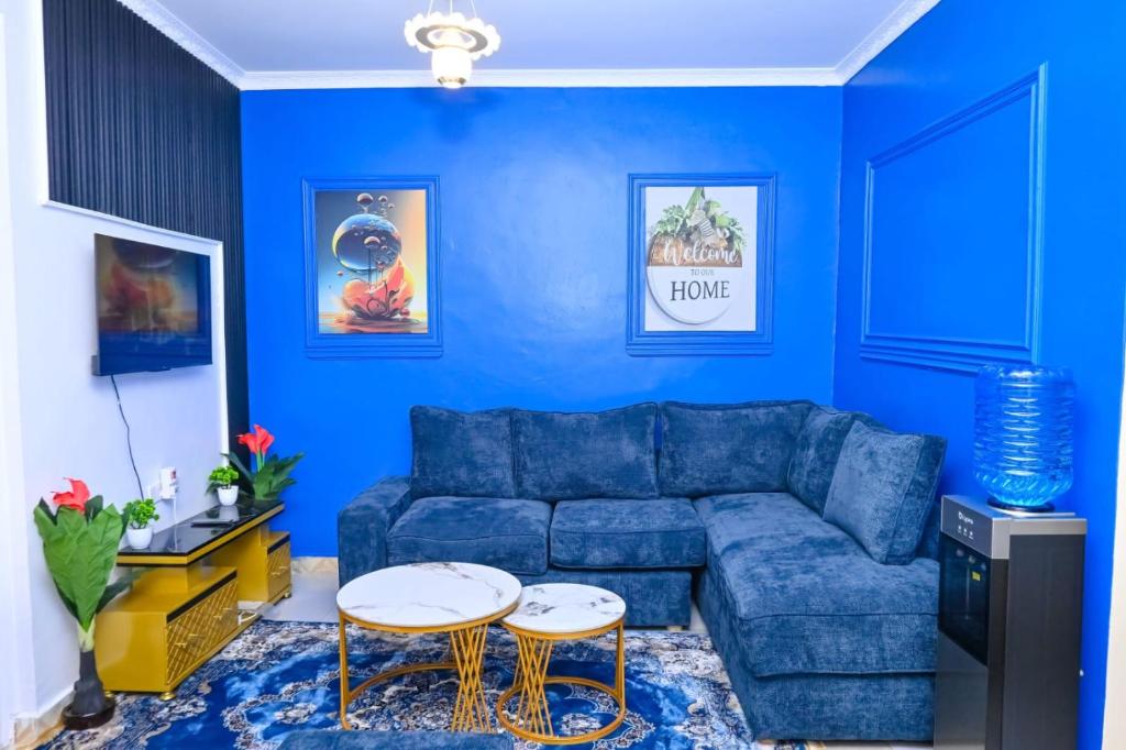 a blue living room with a blue couch and a table at Two Bedroom Free Wi-Fi and Netflix in Nanyuki on your way to Ol Pejeta Conservancy in Nanyuki