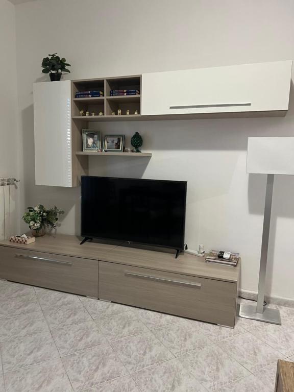 a living room with a flat screen tv on a entertainment center at Artley Home Ladispoli in Ladispoli