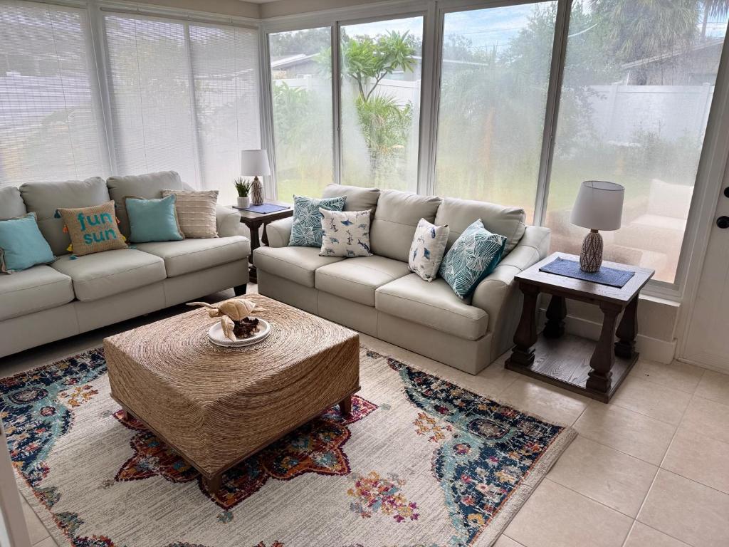 a living room with couches and a large window at Luxury Coastal Retreat in Largo