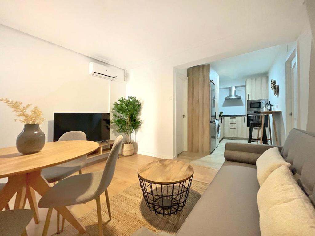a living room with a couch and a table at Lope de Vega by Kaleria Suites in Almería
