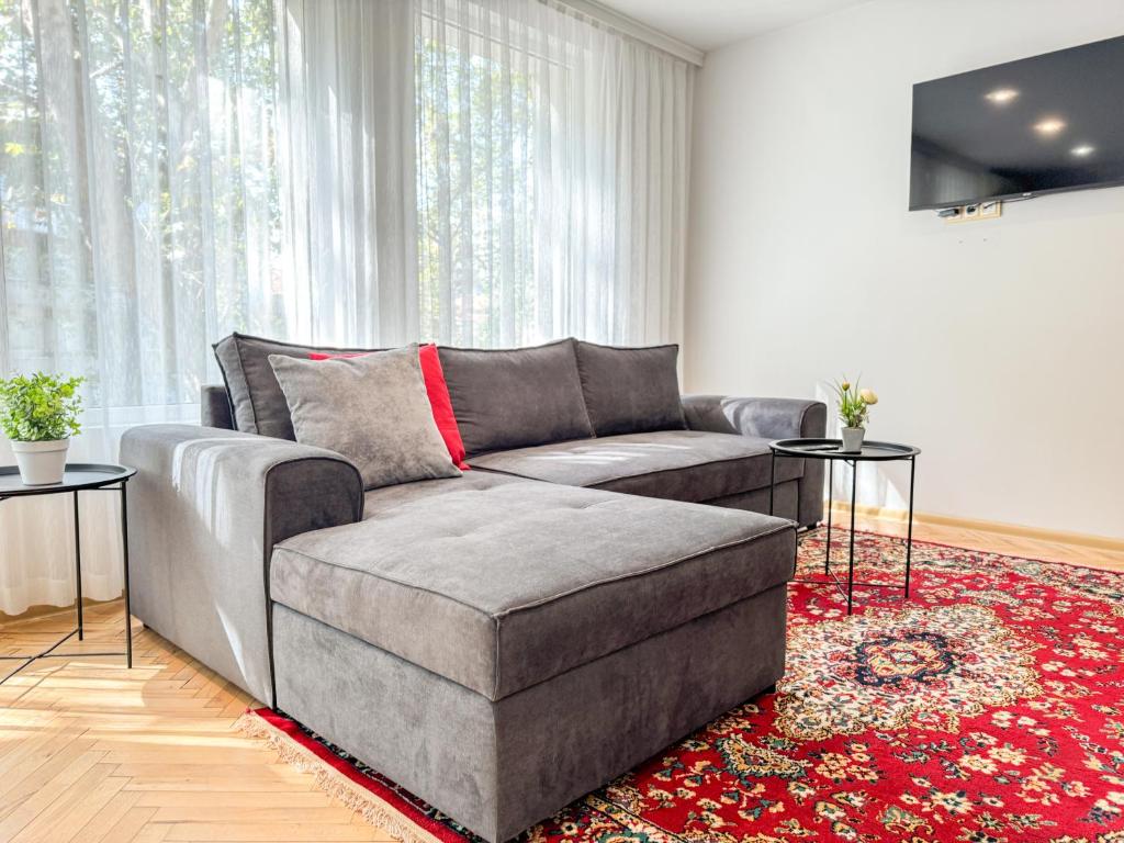 a living room with a couch and a red rug at 2BR Vintage Apt next to Tsar Simeon Garden by Flat Manаger in Plovdiv