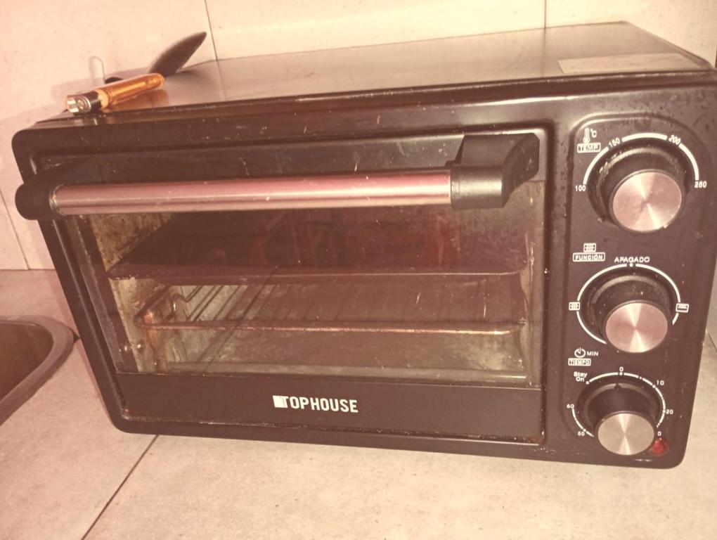 a black toaster oven sitting on top of a counter at Areco en lo de Lily in San Antonio de Areco