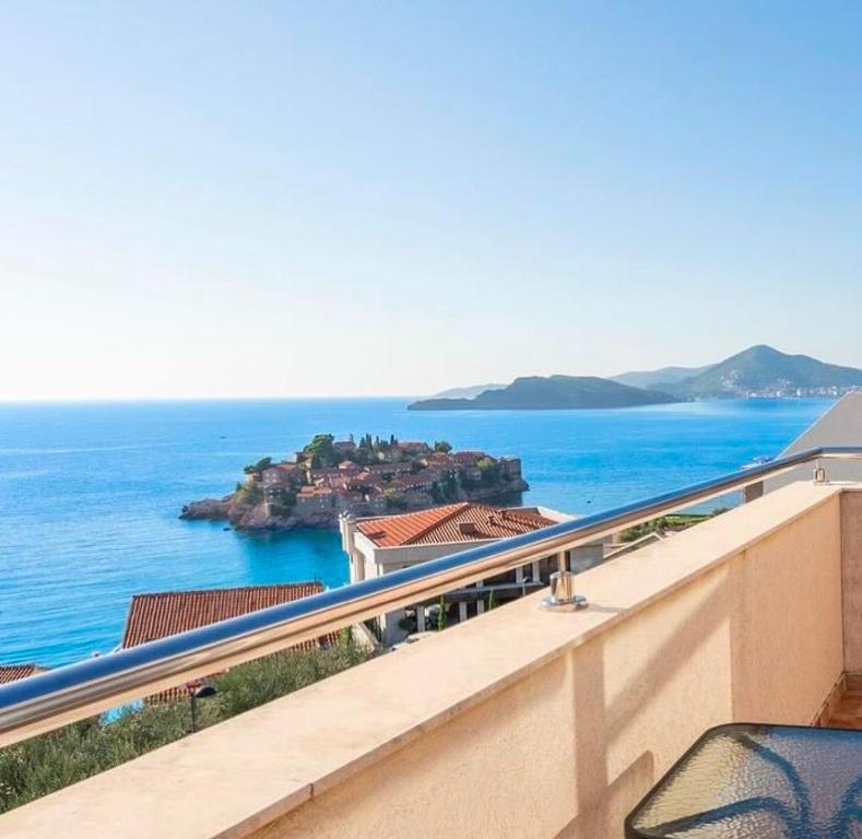 a balcony with a view of the ocean at MILA Adriatic sea view apartment, Sveti Stefan in Sveti Stefan