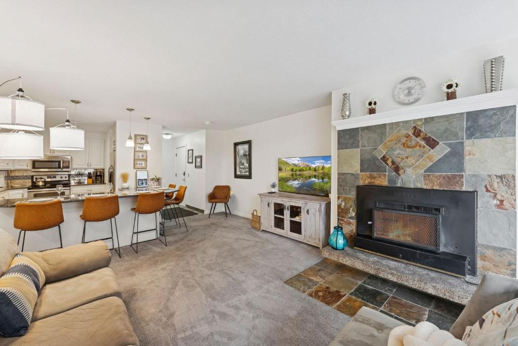 a living room with a couch and a fireplace at Silvertown Powder Pad-on Park Ave Steps to Slopes Shops and Dining in Park City