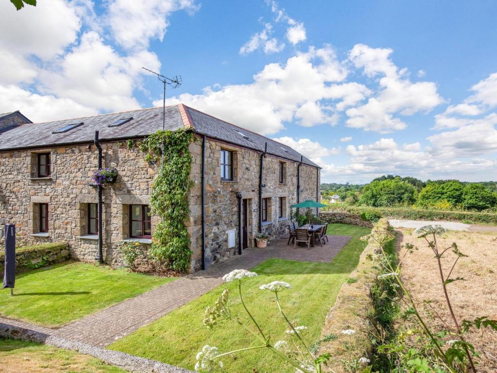 an old stone house with a garden in front of it at 3 Bed in Praa Sands 36258 in Germoe