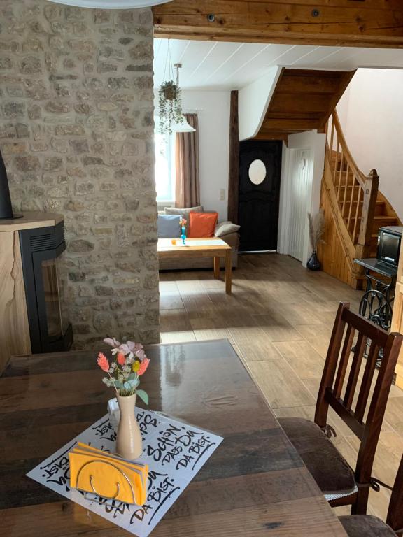 a living room with a vase of flowers on a table at Ferienhaus Brigitte in Schönecken