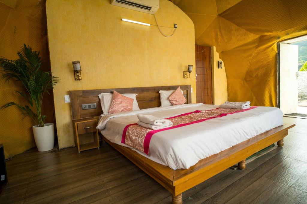 a bedroom with a large bed in a tent at Navira Hills Domes Rishikesh in Shivpuri