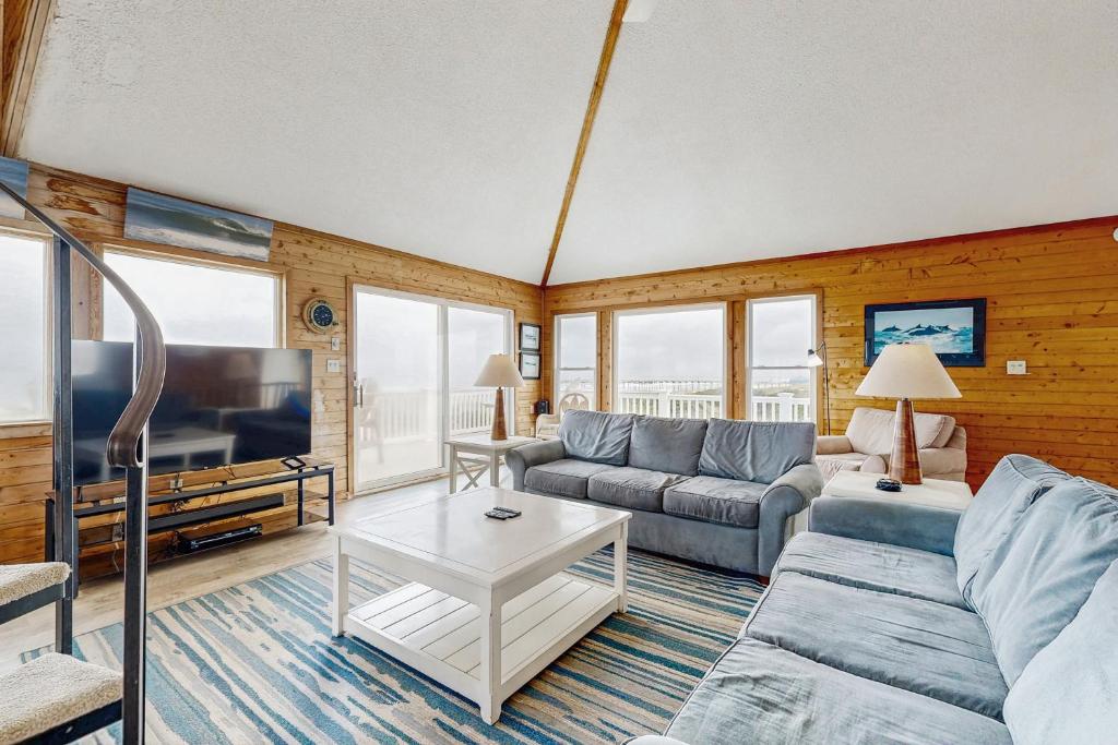 a living room with a couch and a tv at Aah View 242 in Avon