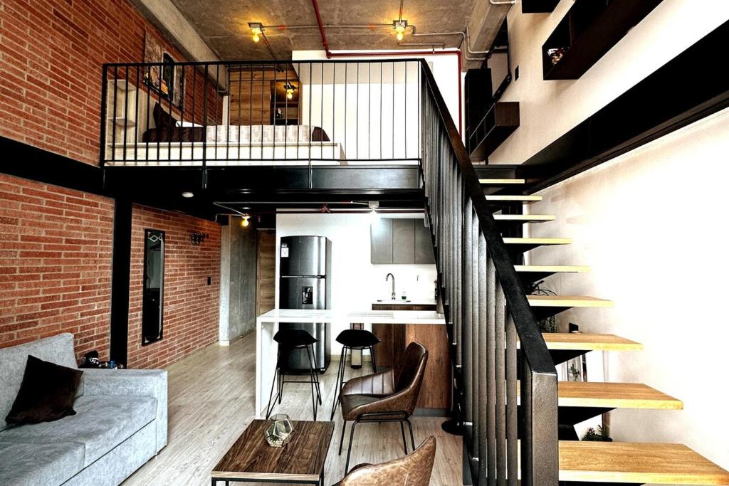 Central Medellin Modern Loft - Balcony and Transit في ميديلين: شقة علوية بها درج وغرفة معيشة